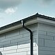 Tagunderlag med PREFA-tagrende, tudstykke til rende og nedløbsrør i antracit med PREFA Siding.X-facade i patinagrå