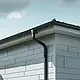 Tagunderlag med PREFA-tagrende, tudstykke til rende og nedløbsrør i antracit med PREFA Siding.X-facade i patinagrå