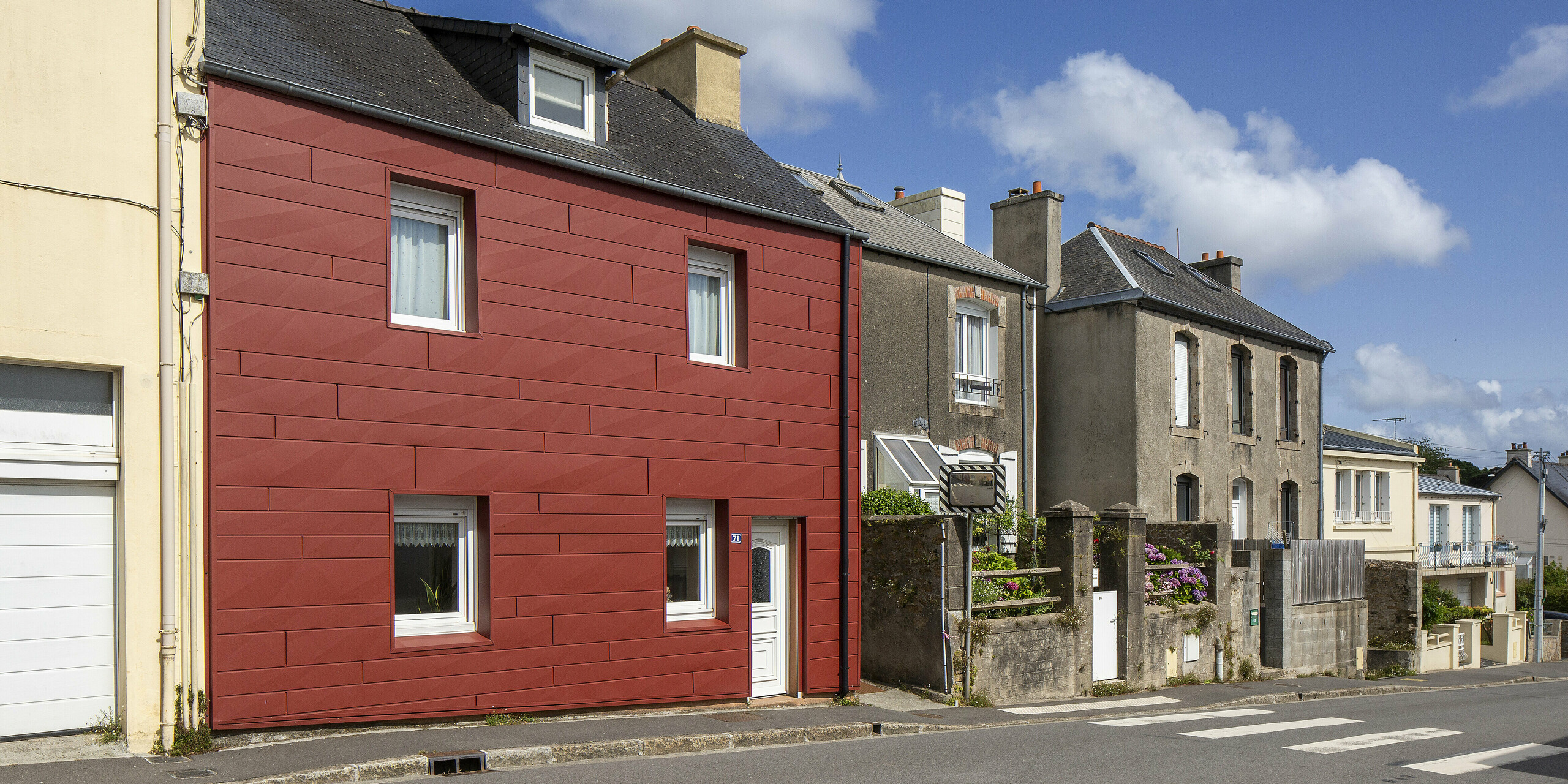 Zwischen traditionellen Fassaden zieht das PREFA-Referenzobjekt mit seinen roten FX.12 Paneelen in Oxydrot alle Blicke auf sich. Die klare Formensprache und die strukturierte Oberfläche setzen einen spannenden Kontrast zur Nachbararchitektur. Eine gelungene Sanierung, die Design, Qualität und Funktion vereint – langlebig, pflegeleicht und architektonisch einzigartig.