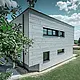 Set fra siden af et moderne enfamiliehus med udsigt til Siding.X-facaden.