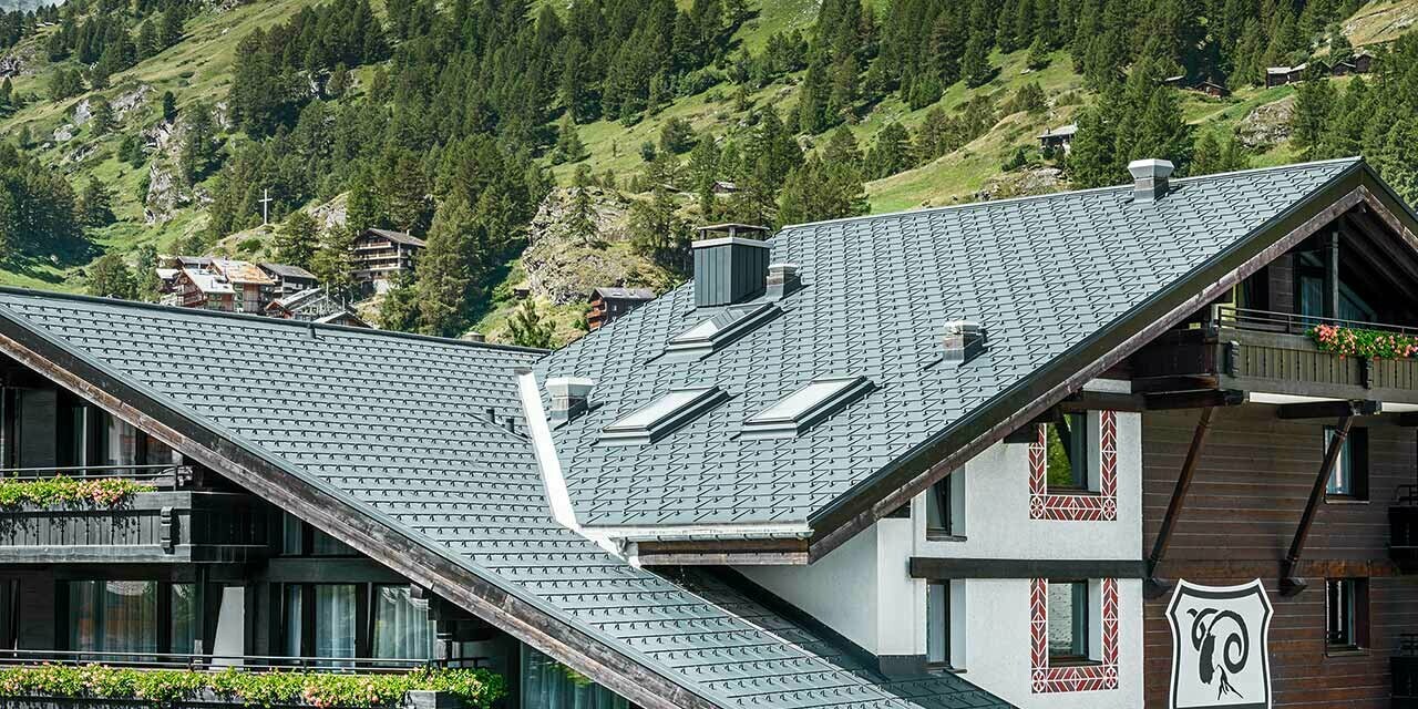 Hotelalpenhof i Zermatt med Matterhorn i baggrunden, balkoner, mørk træfacade og et PREFA aluminiumtag i antracit